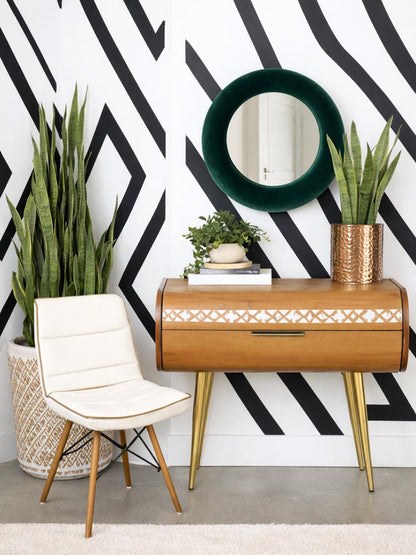 Emerald forest green velvet mirror styled above console table with natural decor