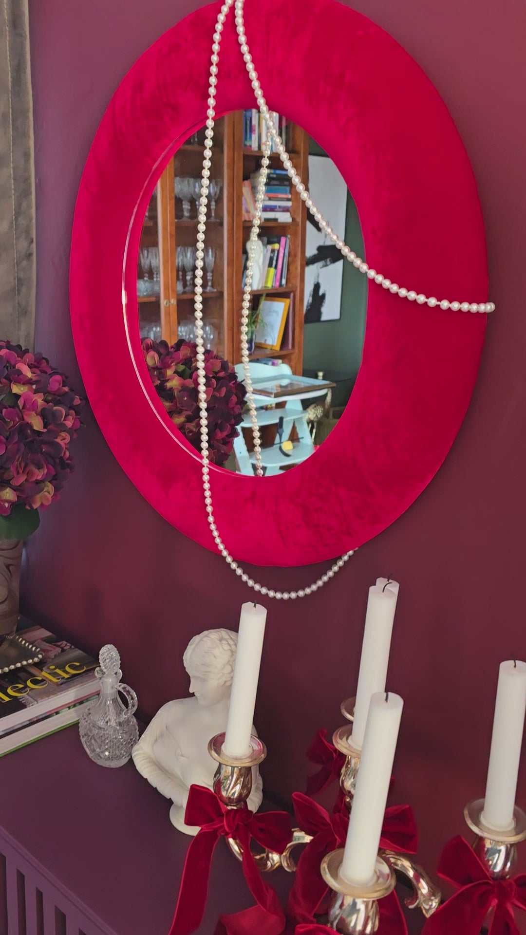 Close up of scarlet red silk velvet mirror frame showing vivid colour and directional pile
